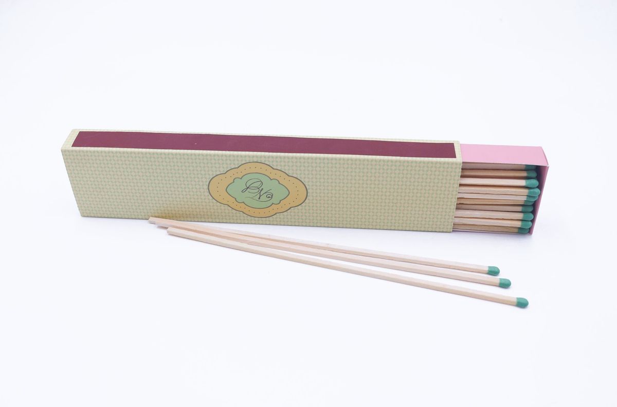 Half-open slide box of long matches revealing the pink inner tray