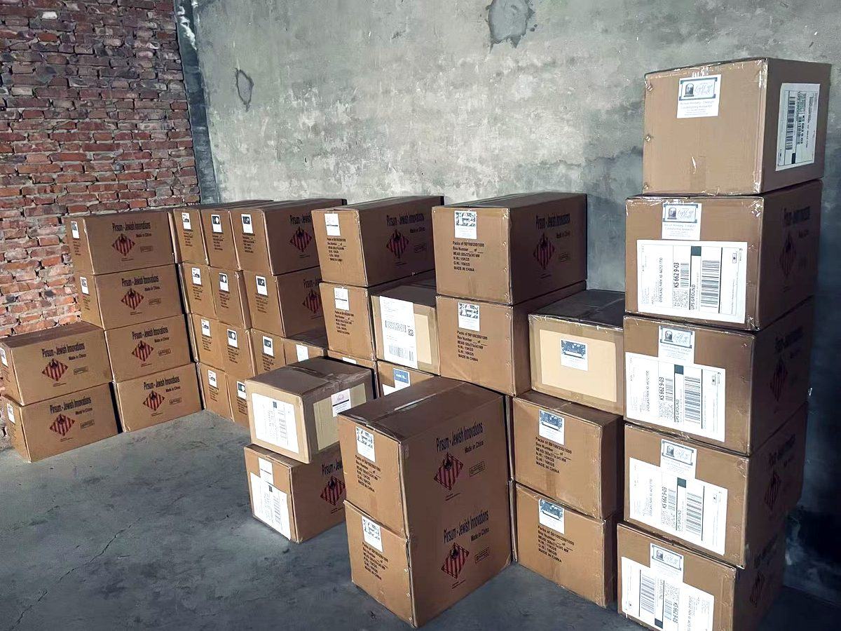 Export cartons of matchboxes stacked in the Safety-Match warehouse, barcode-labelled and ready for container loading